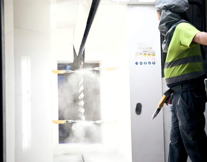 a technician at the SMS facility working on sheet metal finishing